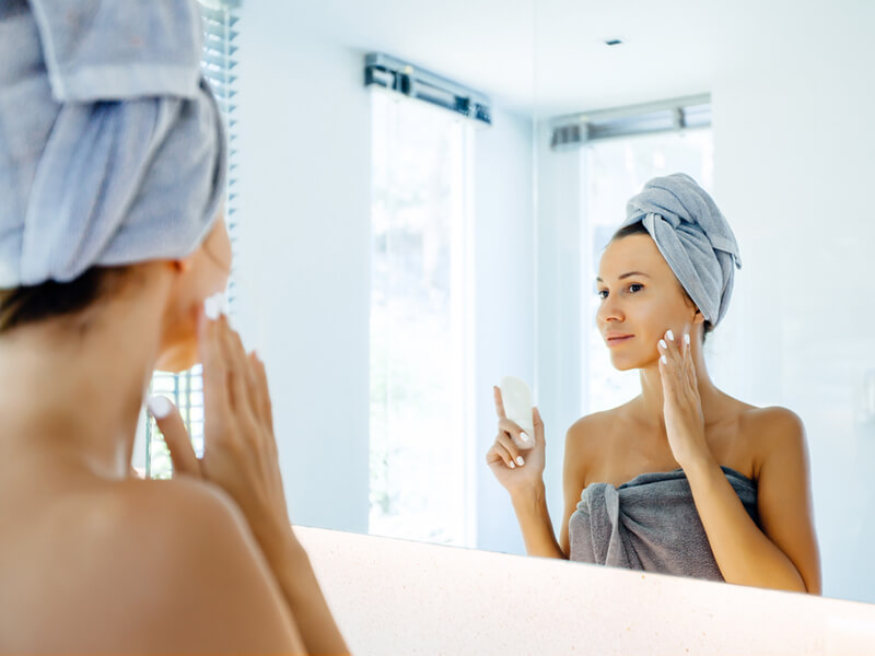 Woman doing her morning skincare routine