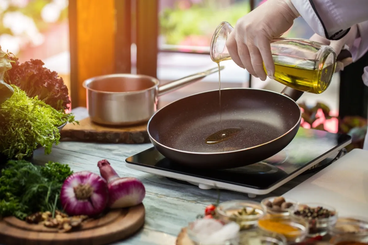 Pouring cooking oil into a frying pan